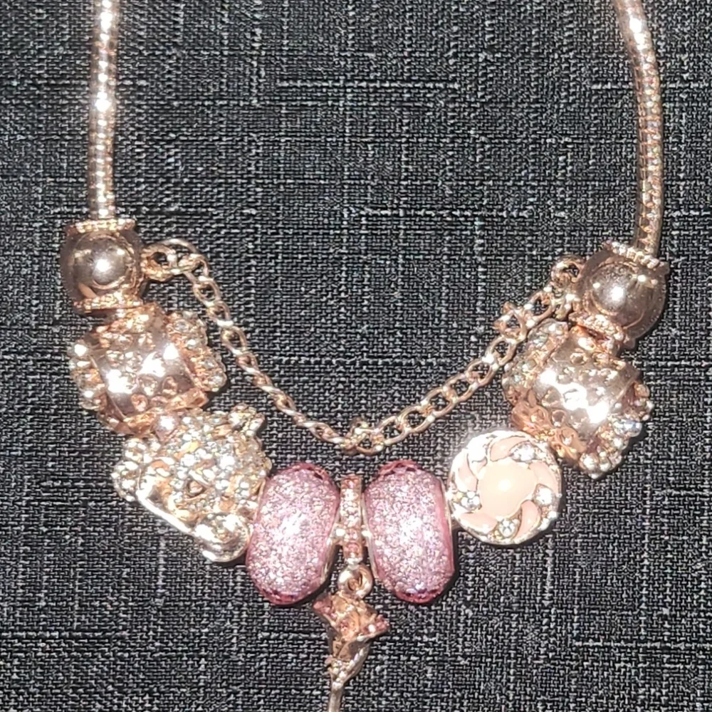Gold and Pink Charm Bracelet with Ornate Charms. ITEM No. 19-144